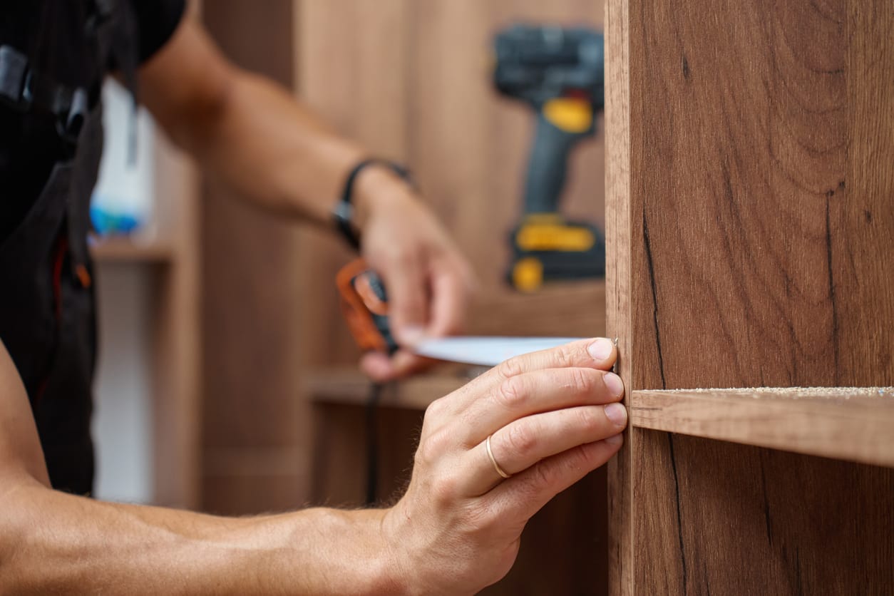 close up of a carpenter measuring wood for a job